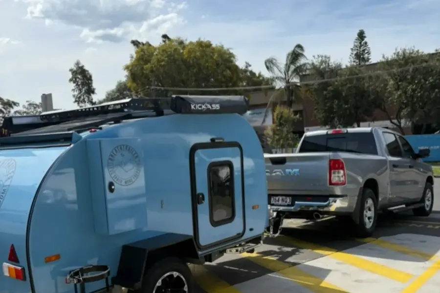 Breath Ultra in sky blue hitched to a silver pickup truck in a car park