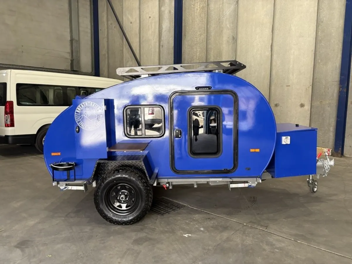 Blue Plus side view with off-road wheels and optional roof rack