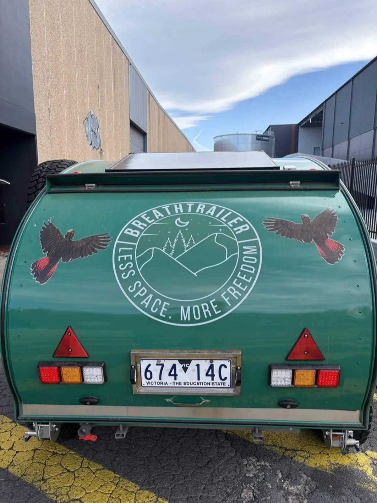 Green Plus rear exterior beside the workshop