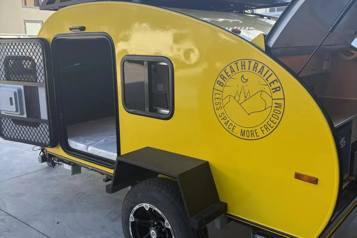 Yellow Plus side exterior with front box and roof rack