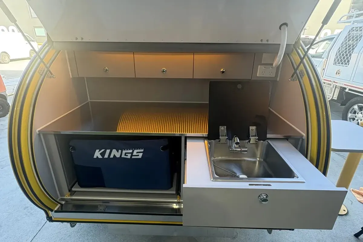 Yellow Plus rear kitchen with open sink drawer and fitted fridge