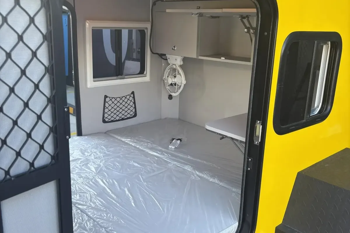 Yellow Plus open security mesh door and mattress inside