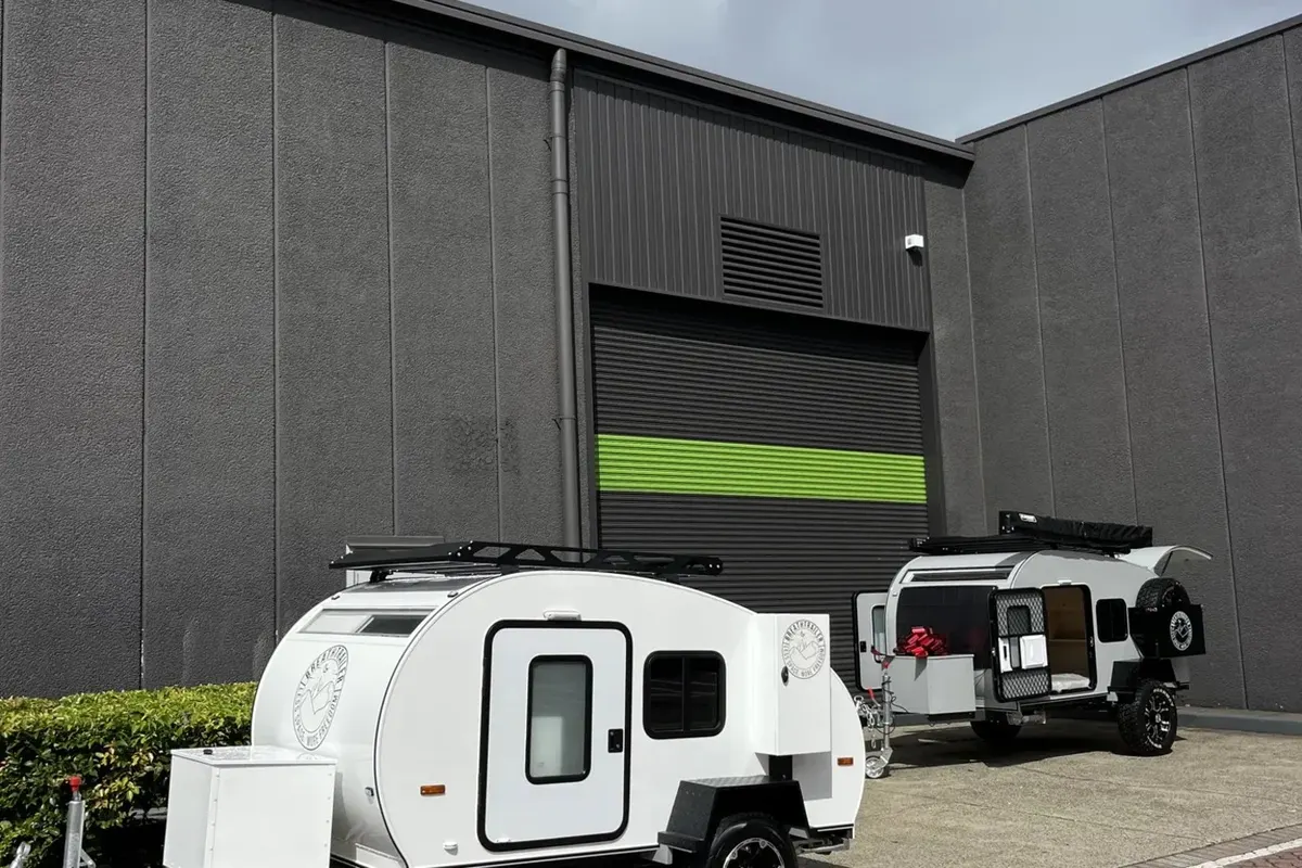 White Plus alongside another completed trailer outside the workshop