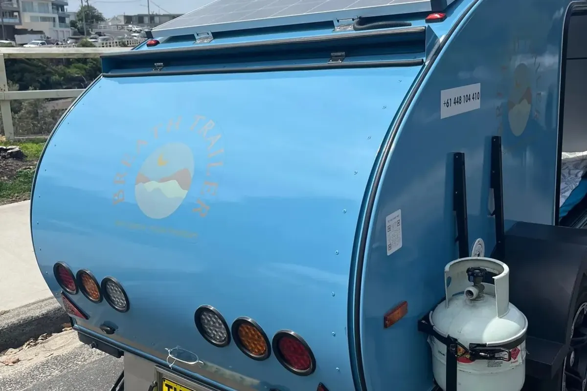Pale blue Plus rear with fixed solar panel on its roof