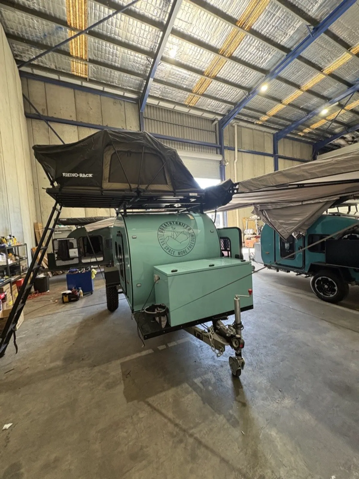 Mint Ultra with optional rooftop tent open in the workshop