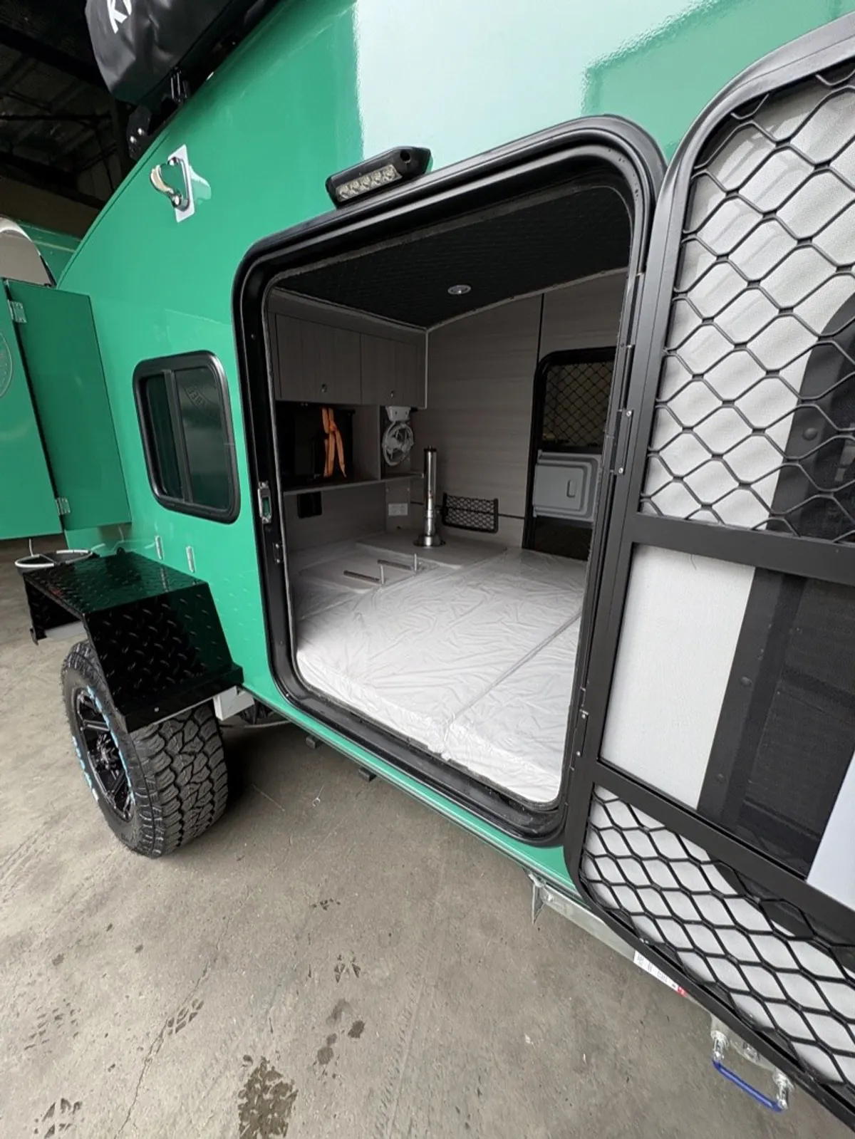 Green Ultra cabin seen through its open mesh doorway