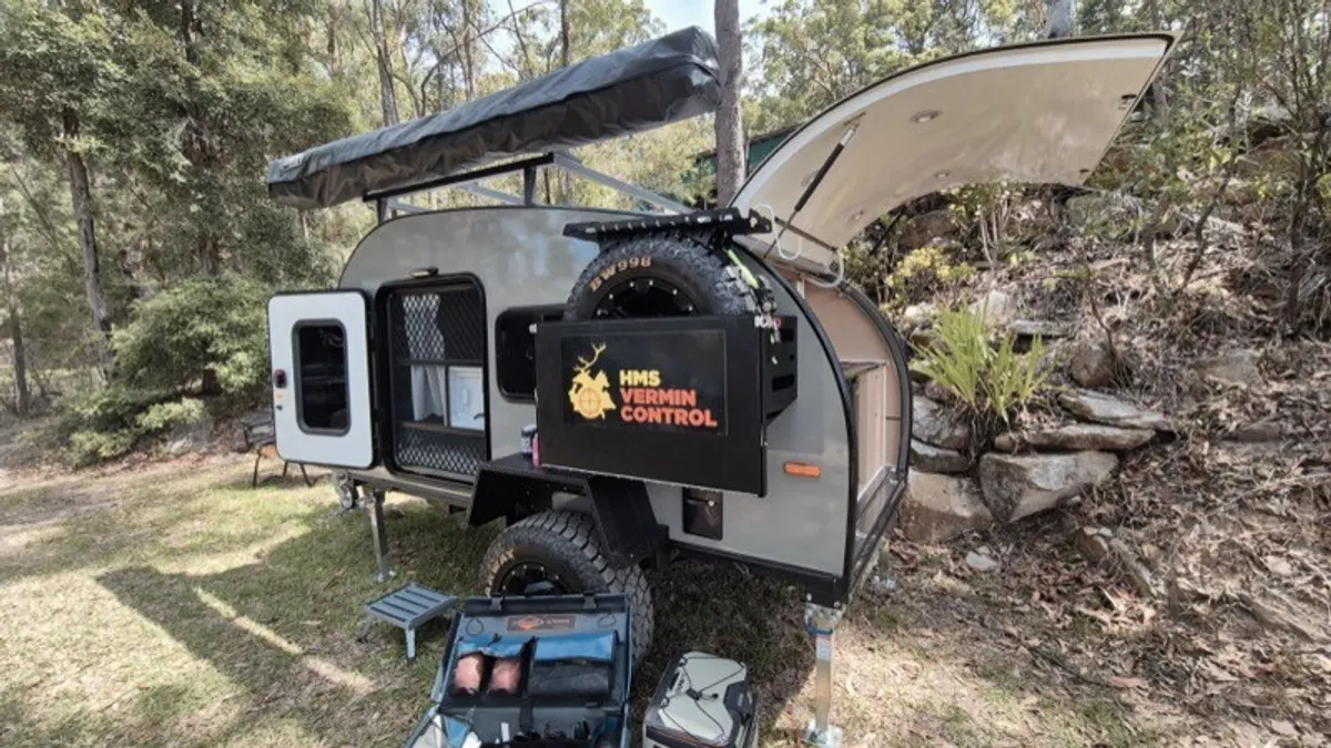 Grey Ultra rear kitchen open beside a rocky campsite