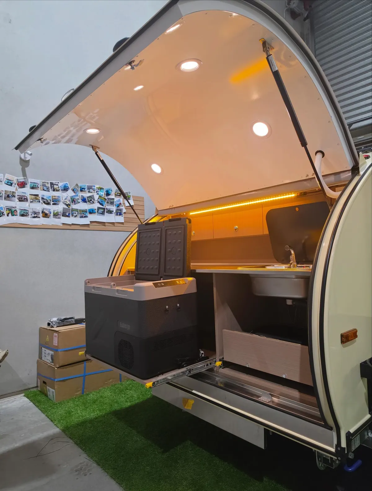 Cream Plus kitchen from the side with larger fridge and amber lighting