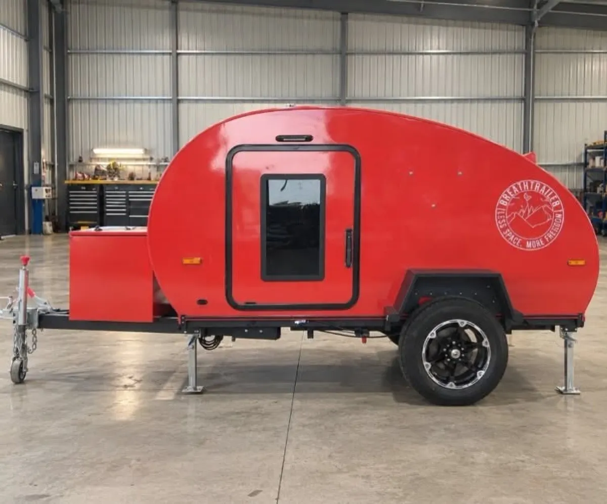 Latest red Breath Plus side profile with red front box and black alloy wheels at the workshop