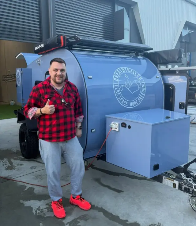 Mariusz with their Breath Trailer at handover