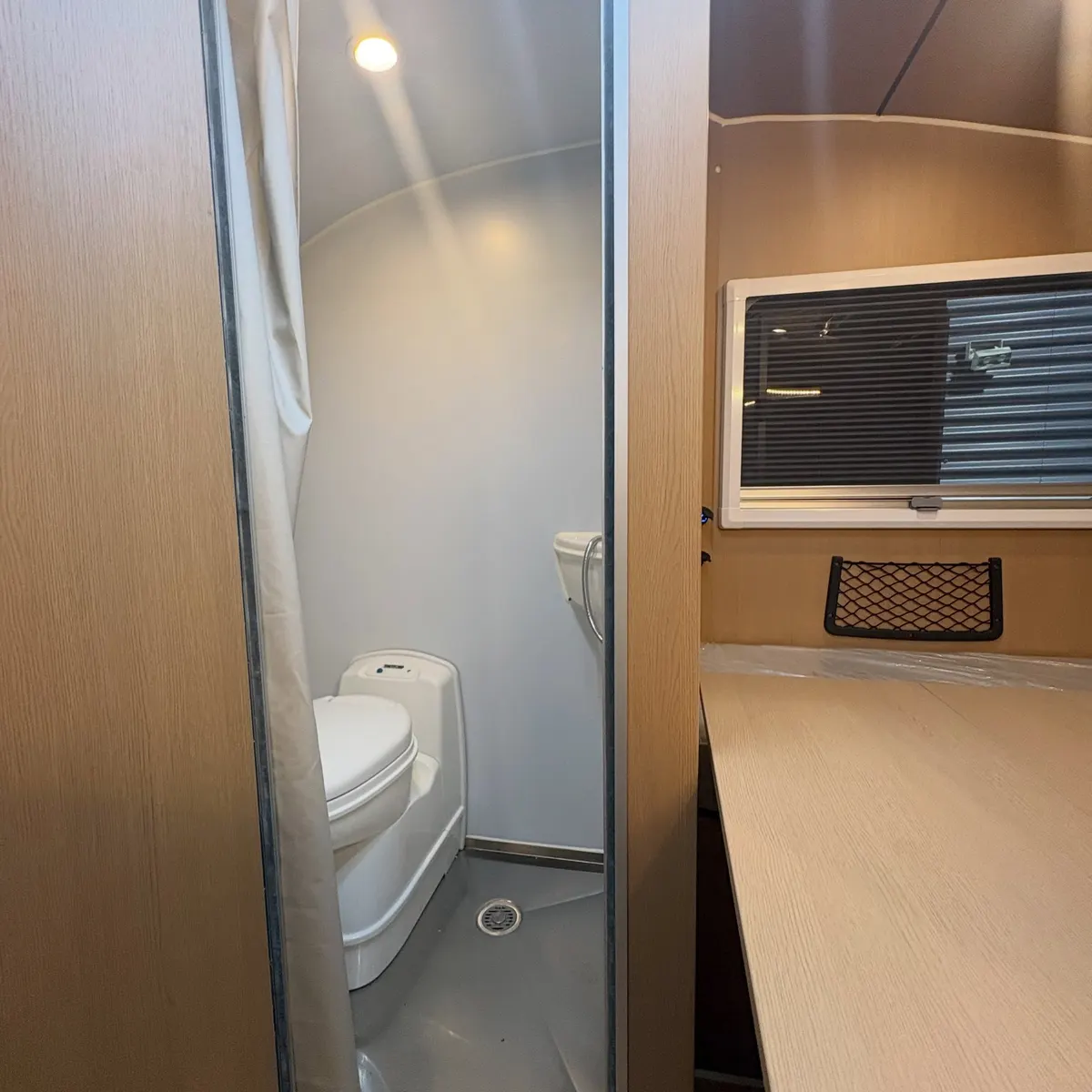Enclosed shower and toilet beside the dining area in Tamara’s Max