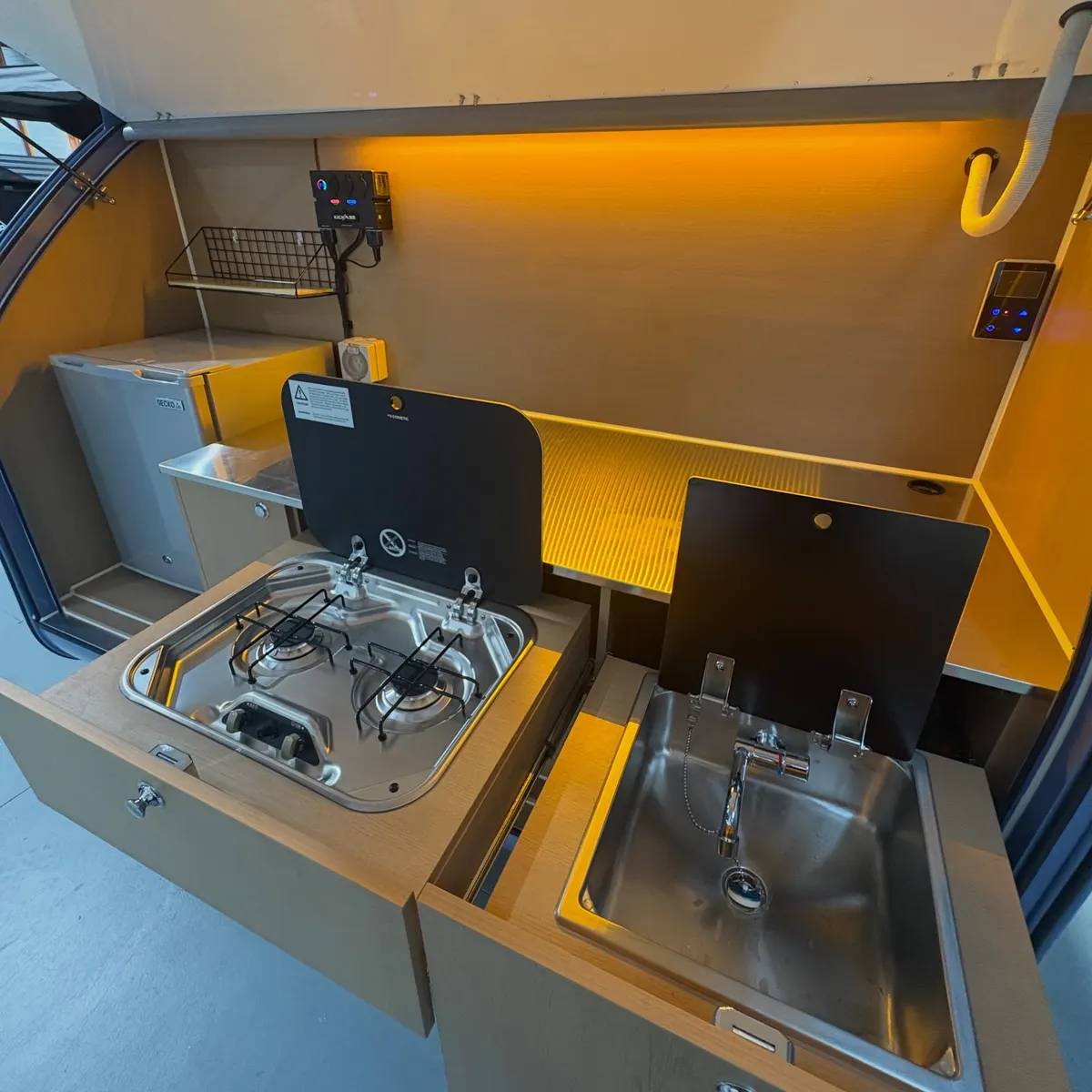 Tamara’s Max rear galley with upright fridge, slide-out sink and double gas stove open