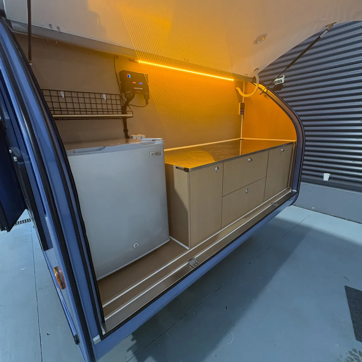 Blue Max open rear galley with fridge, worktop and amber light