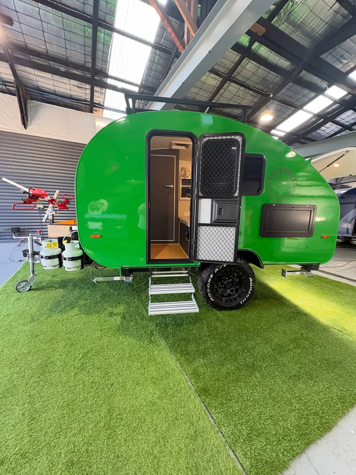 Current green Breath Max Off Road in the showroom with its tall side door open and entry step down