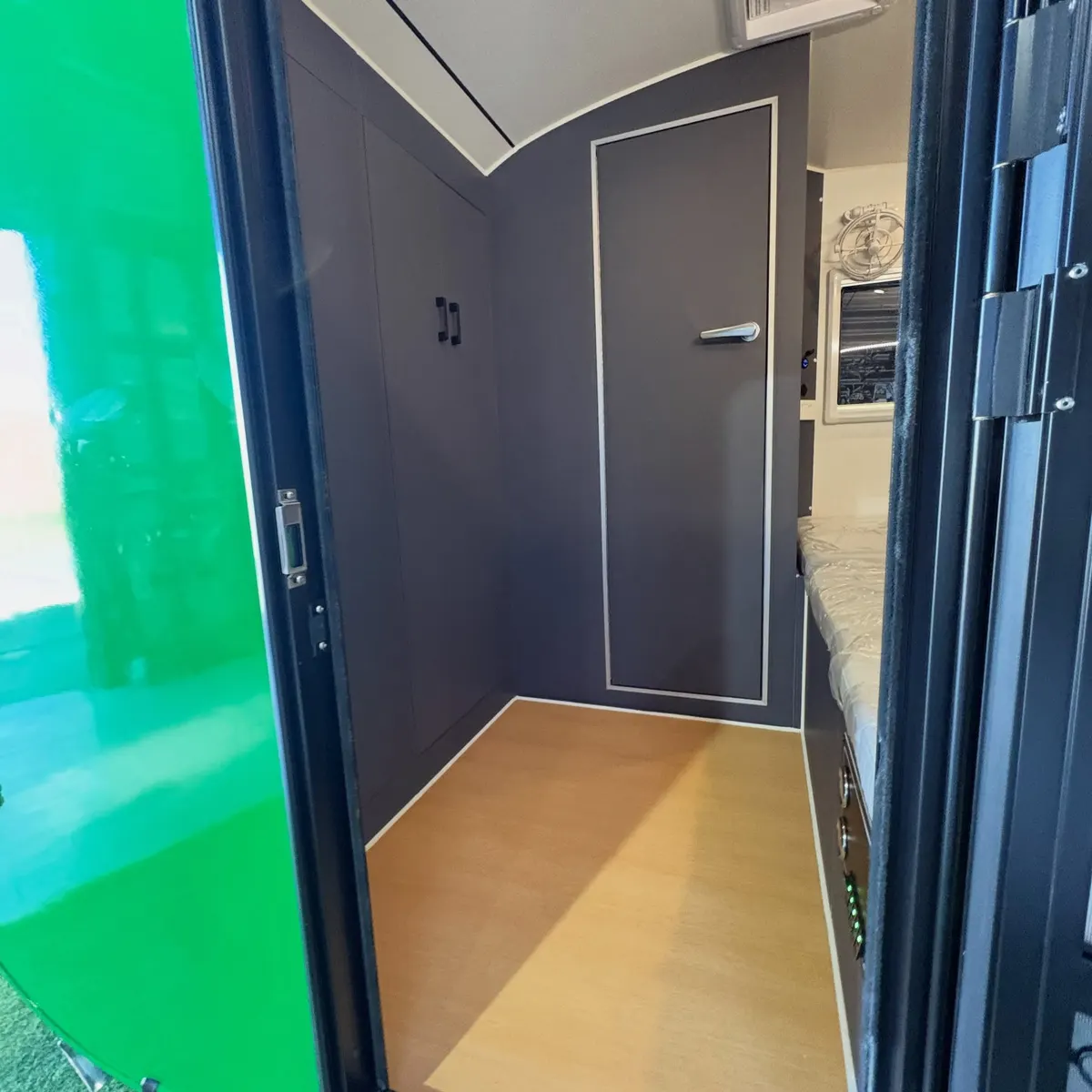 Current green Max full-height interior entry with closed bathroom door