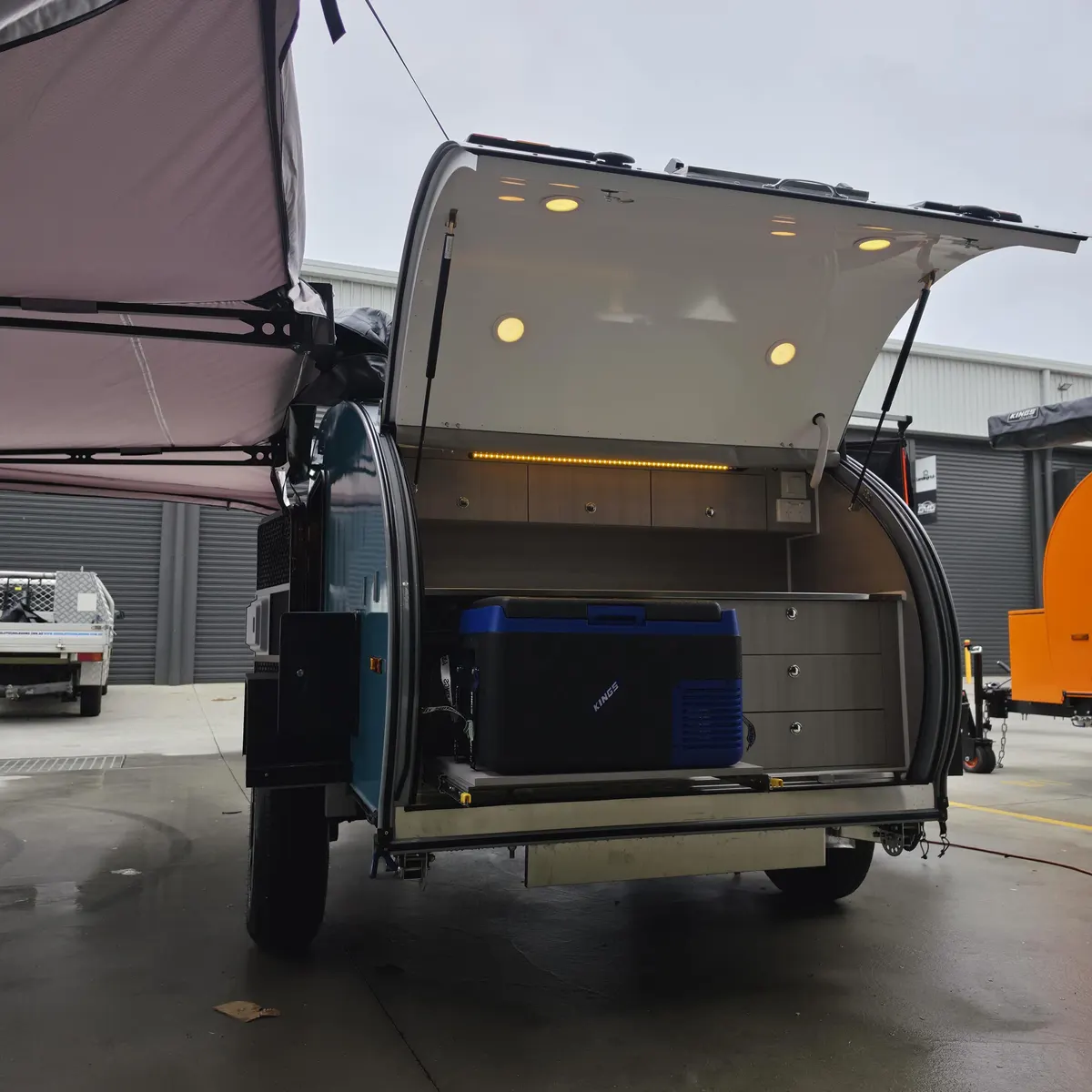 Blue Plus rear kitchen with fridge slide and storage beneath the awning