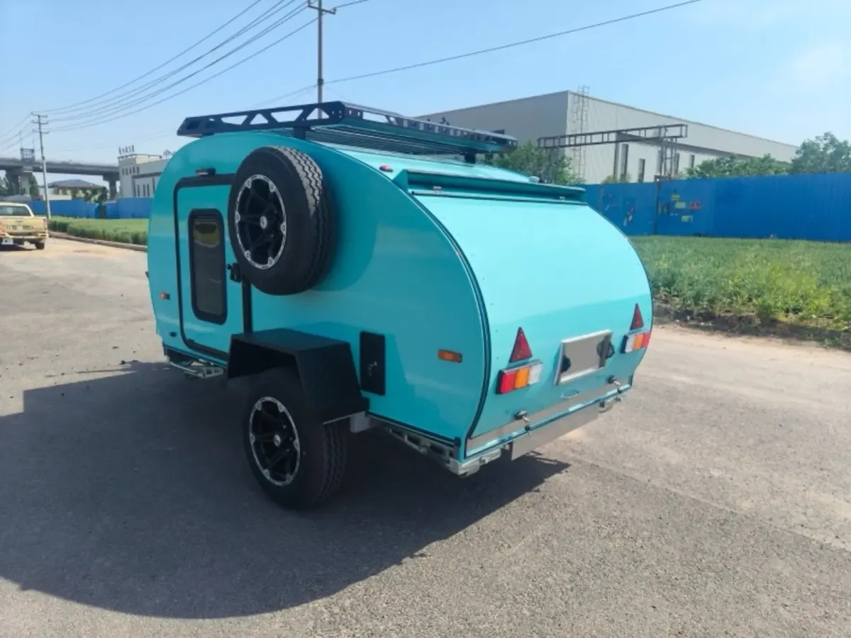 A turquoise Plus with matching front battery box on a quiet road