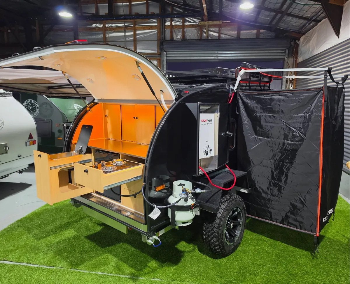 Black Ultra with rear kitchen open and an optional shower enclosure beside it