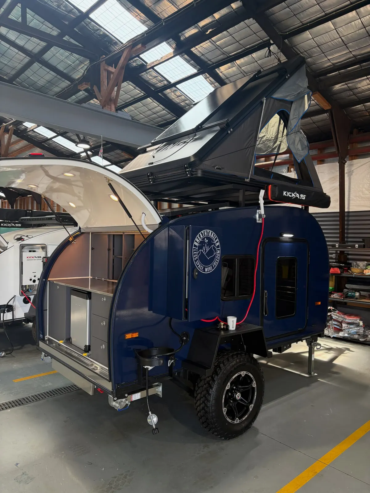 Blue Ultra with an optional rooftop tent and rear kitchen open