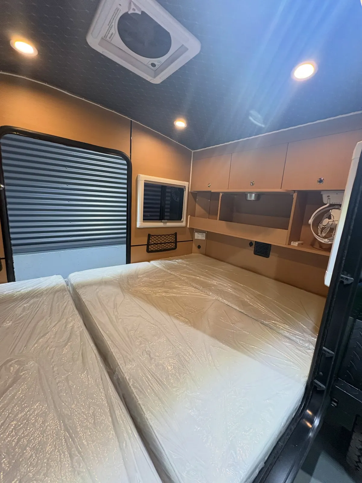 Ultra cabin with mattress, storage, window blind and skylight fan